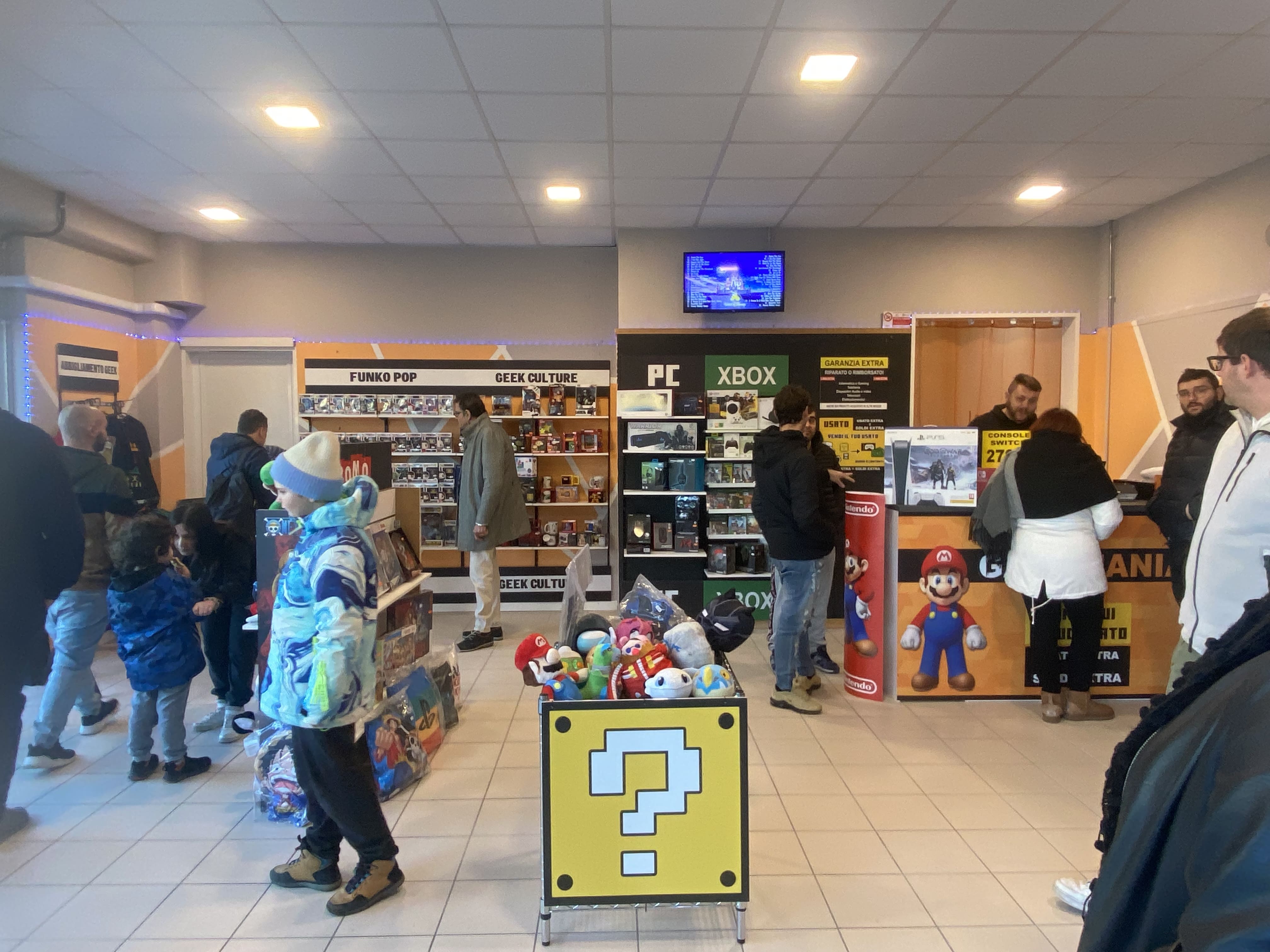Panoramica interna scaffalature e espositori negozio Gamemania specializzato in TCG